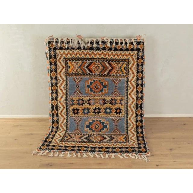 Wonderful Vintage Berber rug with long fringes from the 1960s. Wonderful pile with patterns in creamy white, orange, black...
