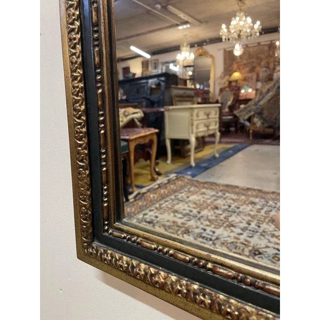 A beautiful rectangular mirror with a gently curved top. Features a parcel and giltwood , nicely detailed frame. In very...