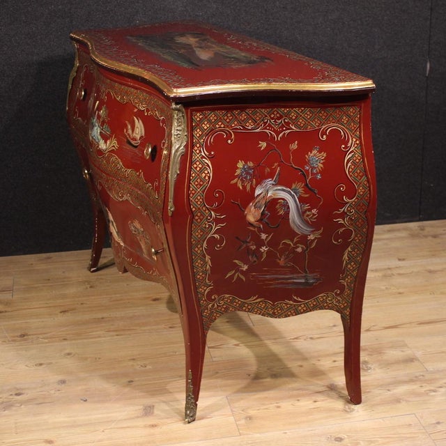 French commode from the second half of the 20th century. A curved furniture, richly lacquered, gilded, and hand-painted...