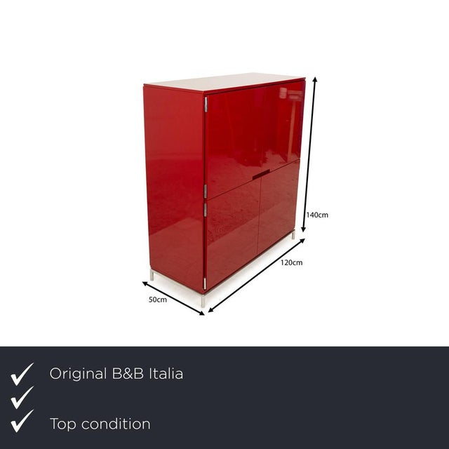 The sideboard from B&B Italia is made of red lacquered wood with a high-gloss finish and stands on short metal legs. with...