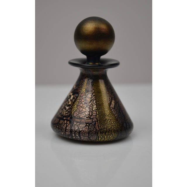 Elegant blown-glass perfume bottle created by Isle of Wight Studio Glass, England, circa 1970s. This piece features rich...