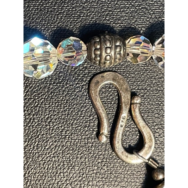 This striking single-strand necklace pairs brilliant, light-refracting Aurora Borealis crystal beads with intricate...