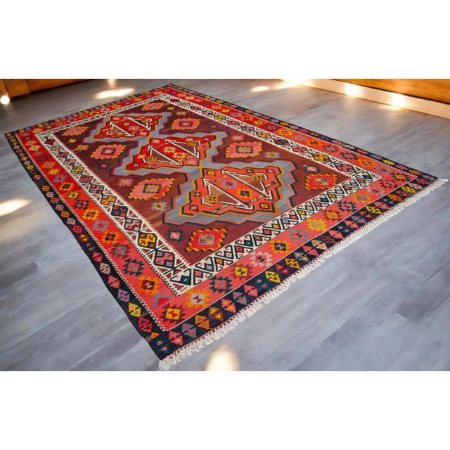 Transform your space with this vibrant, 8x14 ft handmade Turkish Kilim rug, boasting natural dyes that are over 50 years...