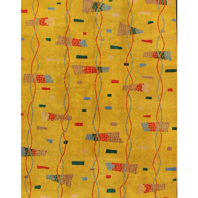 This beautiful Mid-Century rug rests on a saturated yellow background with brilliant accent colors. The design consists of...