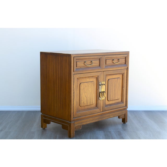 1970's Asian style cabinet of double doors and single drawer This cabinet has minor wear and light scratches consistent...