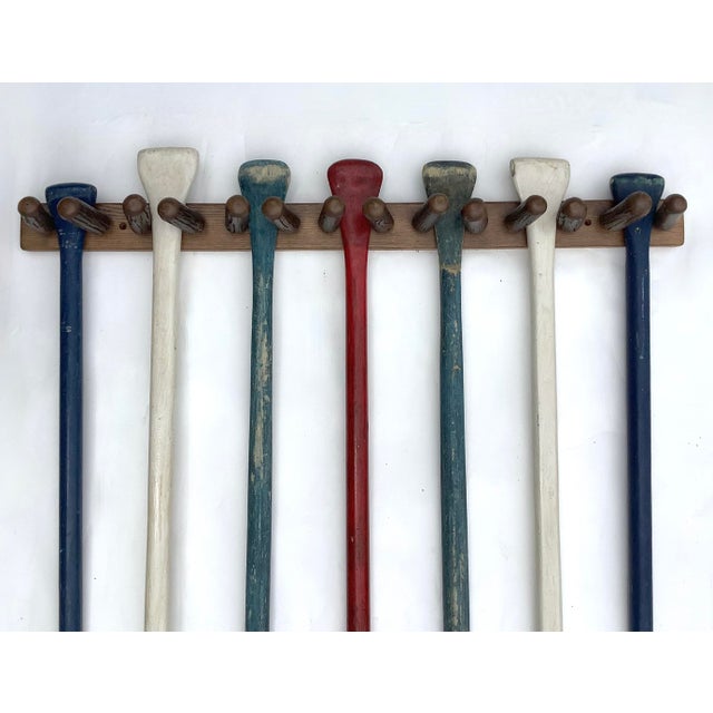 Set of seven vintage canoe paddles in original paint. Set comes with hickory and oak paddle rack in stained finish....