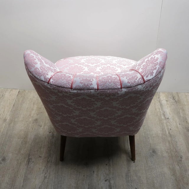 - Vintage cocktail chair reupholstered in pink - Small slanted wooden legs underneath