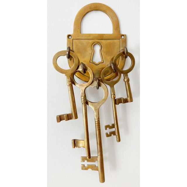 Keep it under lock and key with this unique brass lock wall plate that holds five keys of various size. Longest key...