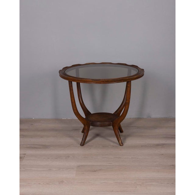 Round coffee table, with wooden frame and smoked glass top, Italian design, 1950s.