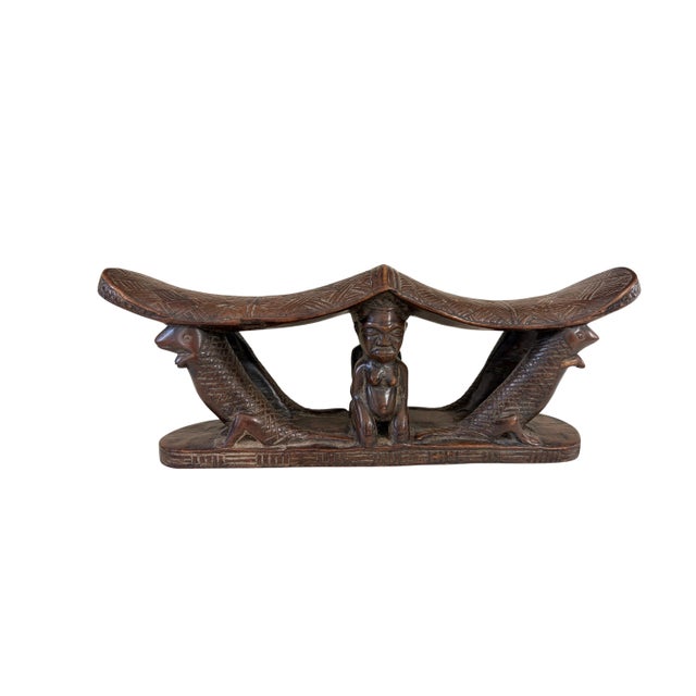 This rare find vintage hand-carved Chokwe double headrest from the Congo features stylized animal figures on either side...