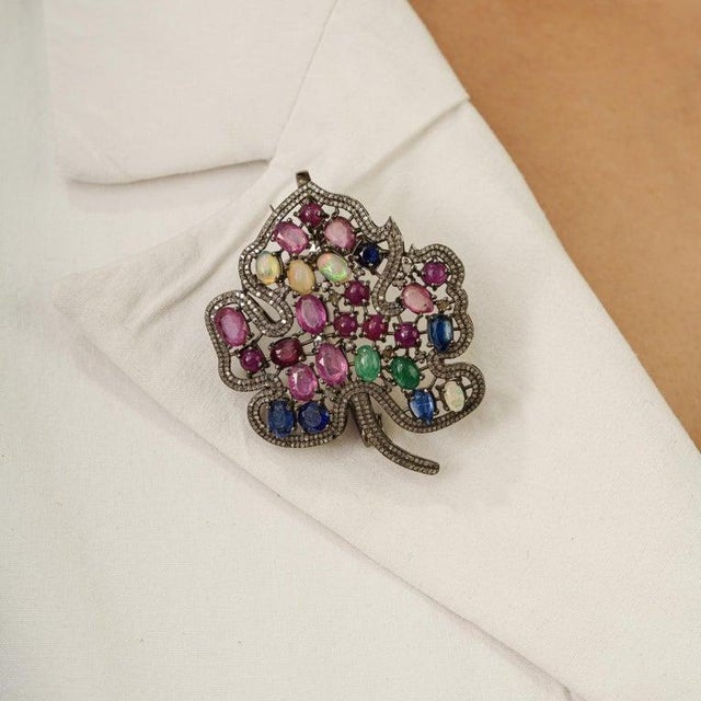 This elegant 9.15 carat multi-gemstone and diamond maple leaf brooch pendant is crafted in 925 sterling silver, featuring...