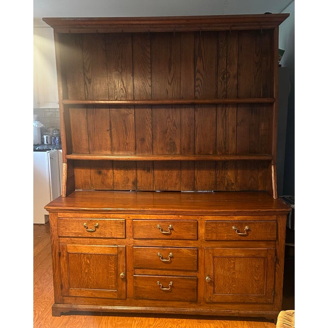 Beautiful antique 1700s welsh dresser from England, full of character. Original brass hardware and cup hooks on top. Two...