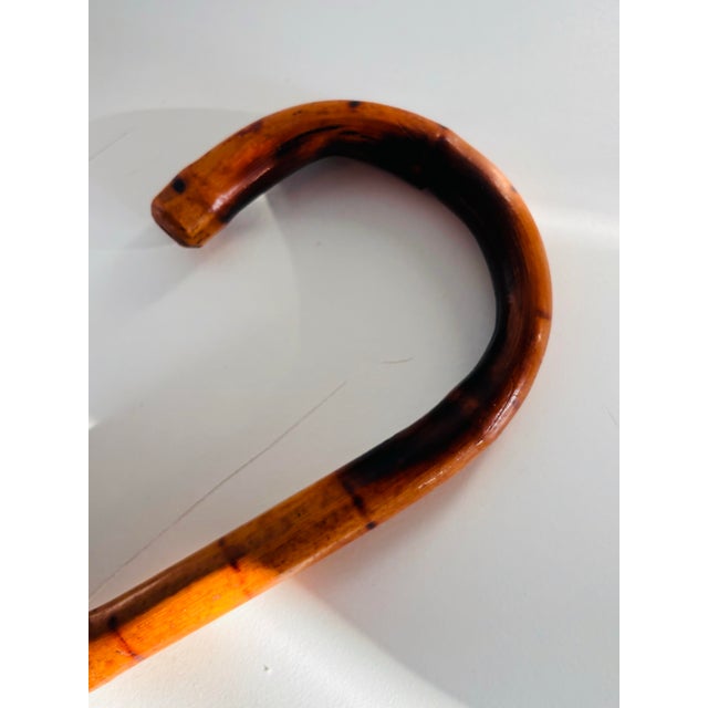 A rather fantastic and unusual walking stick/ cane. Crafted in a burnt bamboo. A unique piece to add to your collection.