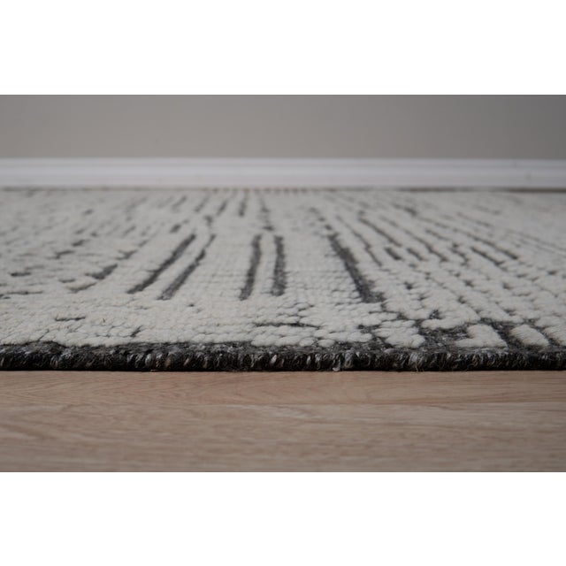 Sloane Sophisticated Ivory Hand Knotted Wool Rug, Country of Origin: India. This exceptional piece showcases the evolving...