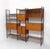A substantial mid-century Ladderax teak and black metal six bay shelving system, with desk and cabinets. Designed by...