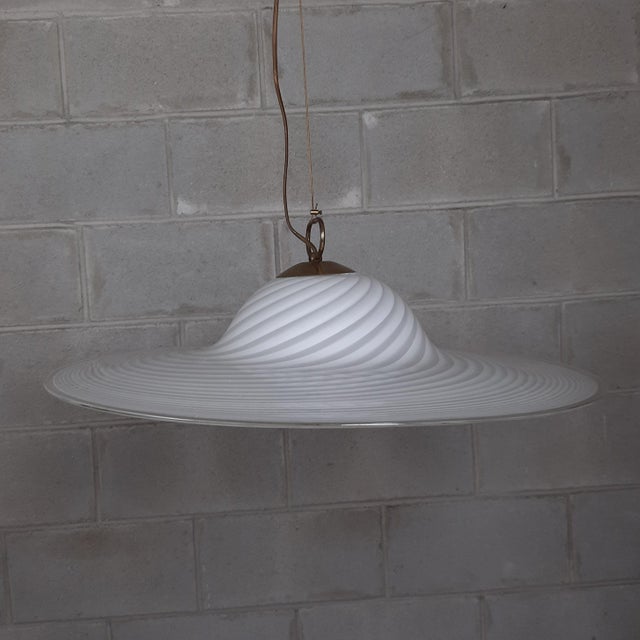 Stunning modern Italian swirl chandelier, in white Murano glass with fantastic spiral design, and polished brass details....