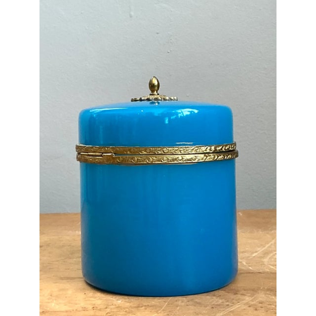 Exuding classic French elegance, this early 20th-century decorative box is crafted from vibrant turquoise-blue opaline...