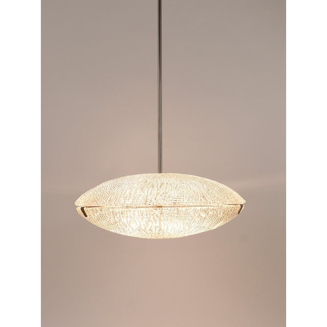 A minimalistic mid-century discus chandelier from the 1950s. Manufactured by j.t. Kalmar, vienna, austria. This beautiful...