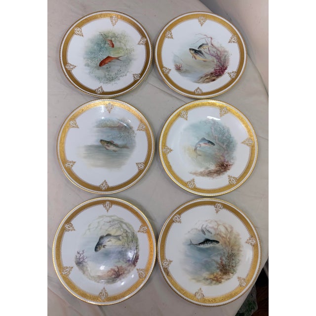 Up for sale is a set of 6 antique hand-painted Limoges porcelain fish plates from the turn of the century. These round...
