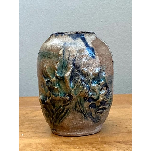 Handcrafted during the mid-20th century, this vintage stoneware studio pottery vase features a bulbous, compact form...