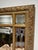 Giltwood-framed mirror by The Bombay Company, featuring an ornate floral border complemented by a decorative geometric...