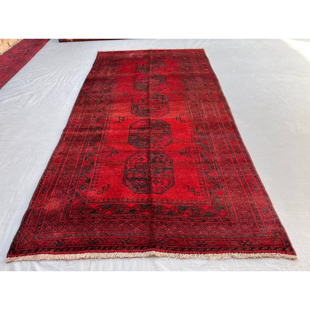 A vintage Afghan Ersari rug in the iconic "elephant's foot" (Fil-pai) design — a single column of five large octagonal...