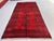 A vintage Afghan Ersari rug in the iconic "elephant's foot" (Fil-pai) design — a single column of five large octagonal...