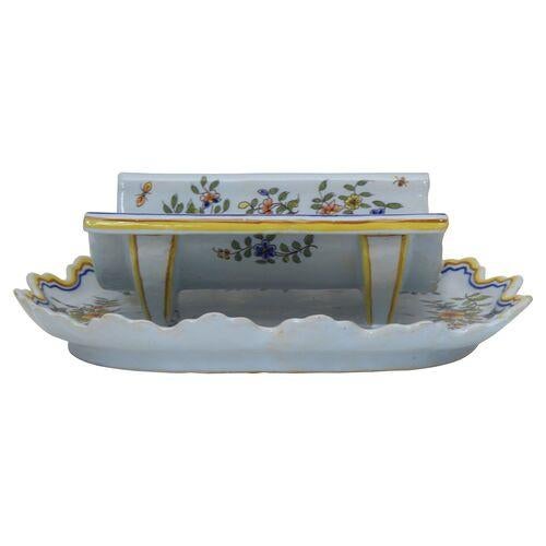 Antique French faience asparagus serving cradle with a coat-of-arms decoration, draining holes, and attached underplate....