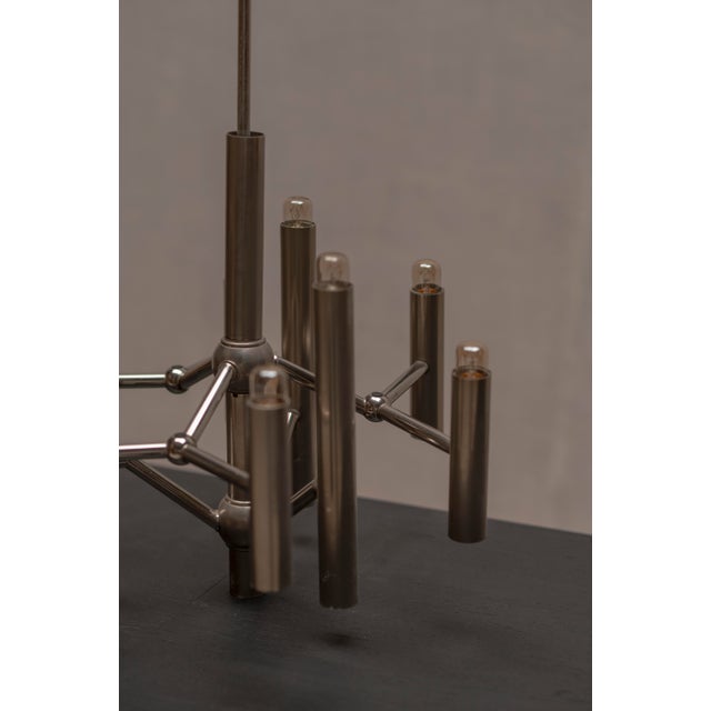 Elegant space age chandelier from the 1970s, executed in metal with a beautiful original patinated finish. Defined by its...