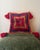 A vivid vintage accent pillow featuring a textured handwoven geometric face in saturated red, navy blue, mustard gold, and...