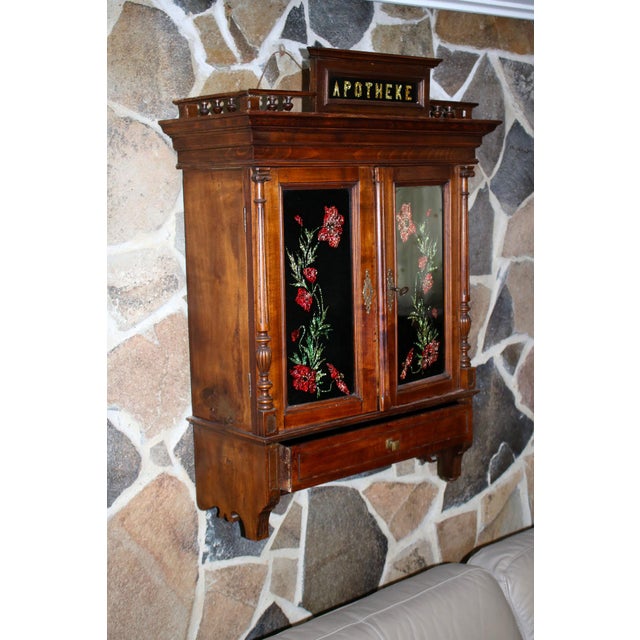 This is a beautiful Late Victorian apothecary cabinet. The letters are beautifully crafted from a gold hued foil, the...