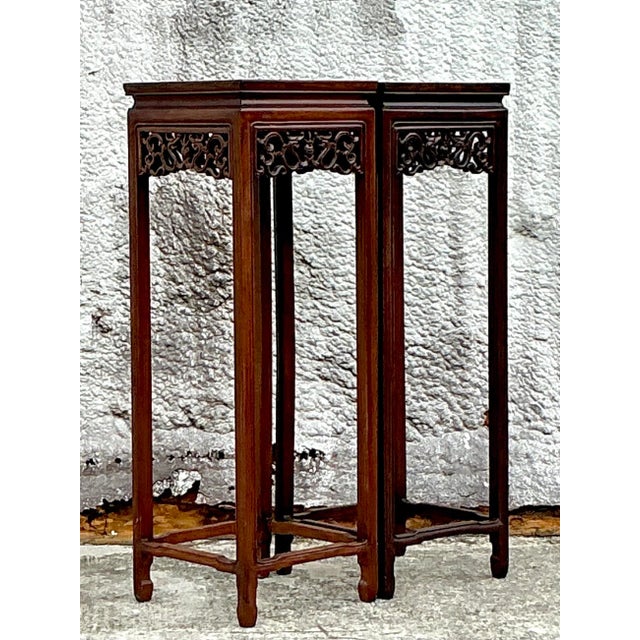Elegant pair of vintage Asian rosewood pedestals, expertly carved with intricate floral and geometric designs. These...