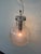 Suspended chandelier with a spherical shade made of Pulese glass. Made in Murano. Made in Italy in the 1960s. The shade’s...