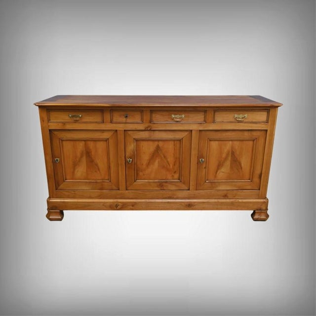 This solid cherrywood sideboard, crafted around 1900, embodies the timeless elegance of French Belle Époque furniture....