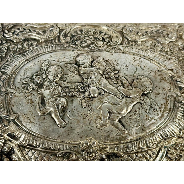 Antique Silverplate Repousse' Cherub Jewelry Box for your consideration. The box measures approx. 8 1/2 inches long, 6 1/2...