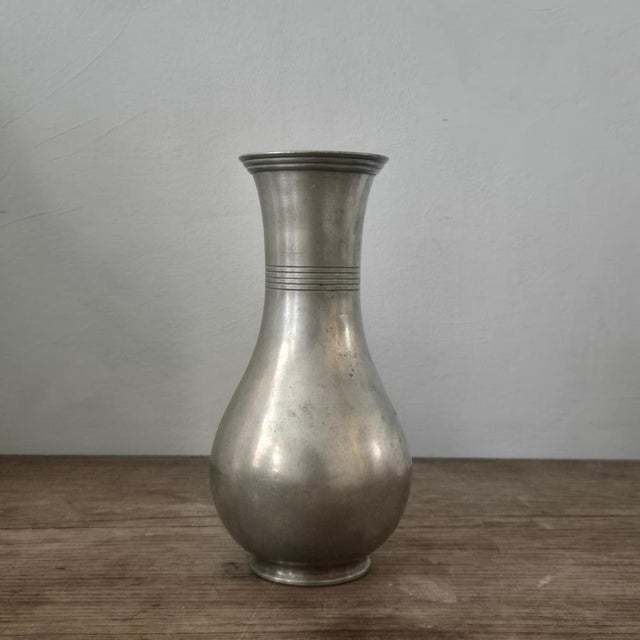 A timeless, decoratiove vase in pewter with decor of stripes, by Guldaktiebolaget. Bottom with hallmarks. In good...