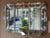 This sensational silver and glass vintage 1940's Hollywood Regency style mirror meets mid century modern is framed with...