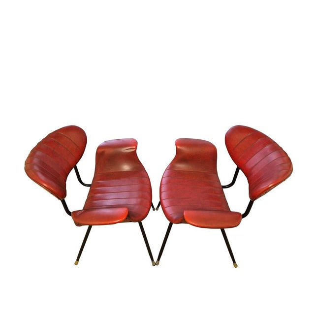 An elegant pair of armchairs designed by Gastone Rinaldi and produced by Rima in the 1950s. The design features a black-...