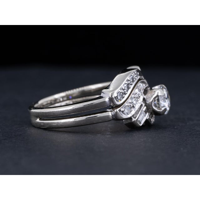 Vintage Art Deco wedding set featuring a bright round brilliant cut diamond accented by round single cut and baguette cut...