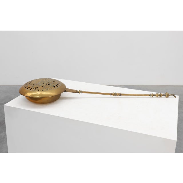 A superb example of early domestic craftsmanship, this hand‑forged brass and copper bedpan from Belgium, circa 1600–1700,...
