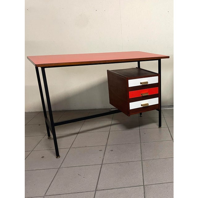 A fully restored 1960s writing desk. A sleek, black lacquered tubular iron frame with adjustable brass feet matches the...