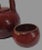 This vintage Asian teapot and two cups set is a must-have for any tea enthusiast. The bright red glaze and intricate...