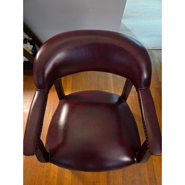 4 Office chairs in excellent condition. Burgundy leather with nailhead trim on casters to facilitate movement in your...