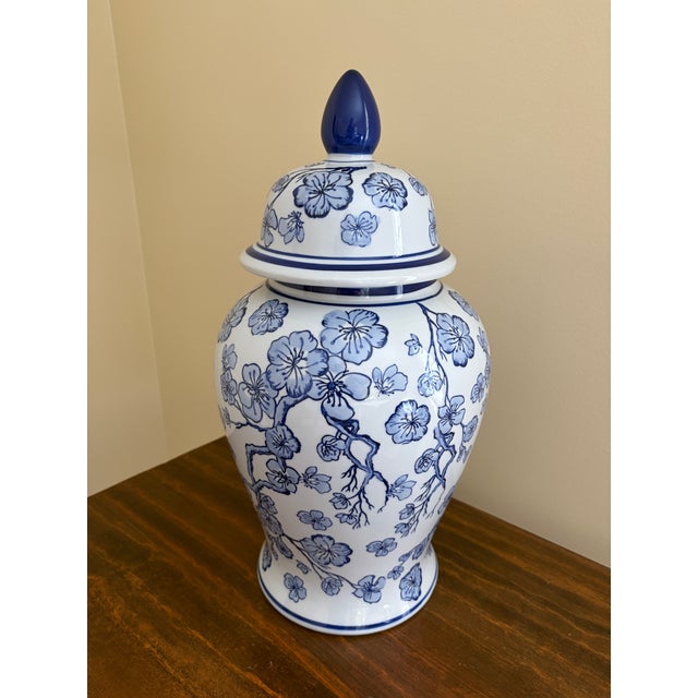 A beautiful large Chinoiserie blue and white porcelain covered ginger jar or temple jar with cherry blossom branches...