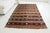This is a vintage Turkish Oushak rug from the Mid 20th Century. The piece was hand-knotted.