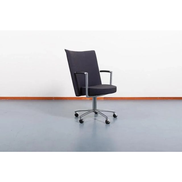 Swivel ‘Partner’ desk chair designed by Johannes Foersom & Peter Hiort-Lorentzen. Upholstered in fabric with armrest in...