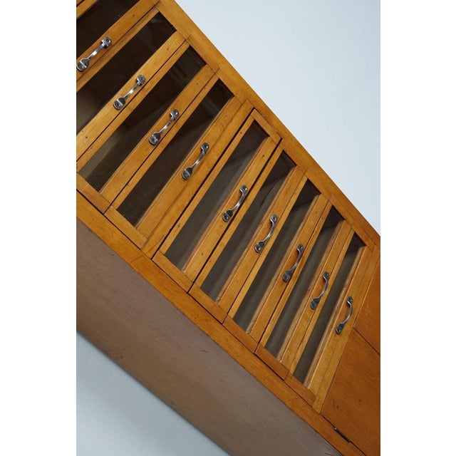 This haberdashery cabinet was produced during the 1950s in the Netherlands. This piece features 10 drawers in light beech...