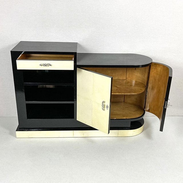 A refined example of art deco design, this elegant storage unit combines geometric shapes, rounded lines, and premium...