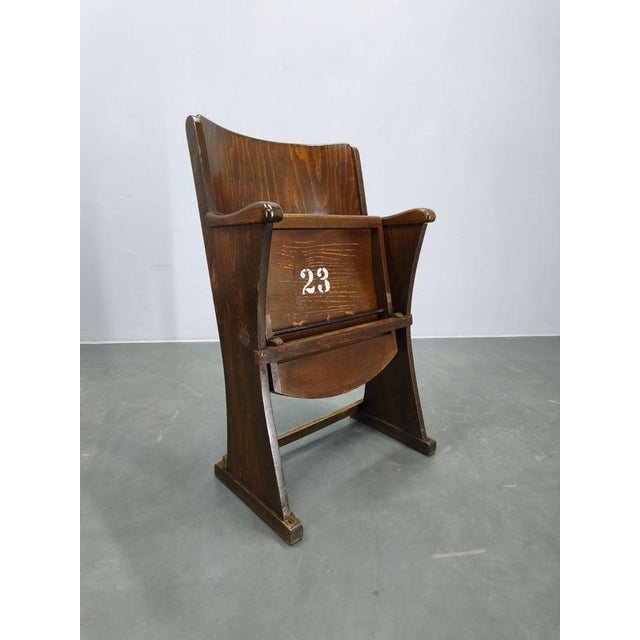 Authentic 1950s vintage cinema chair crafted from solid beech wood and plywood. This original theater seat features a...