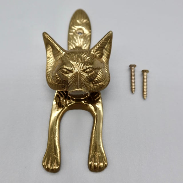 A charming vintage brass fox head door knocker with exceptional detail. Heavy, solid construction with a satisfying weight...